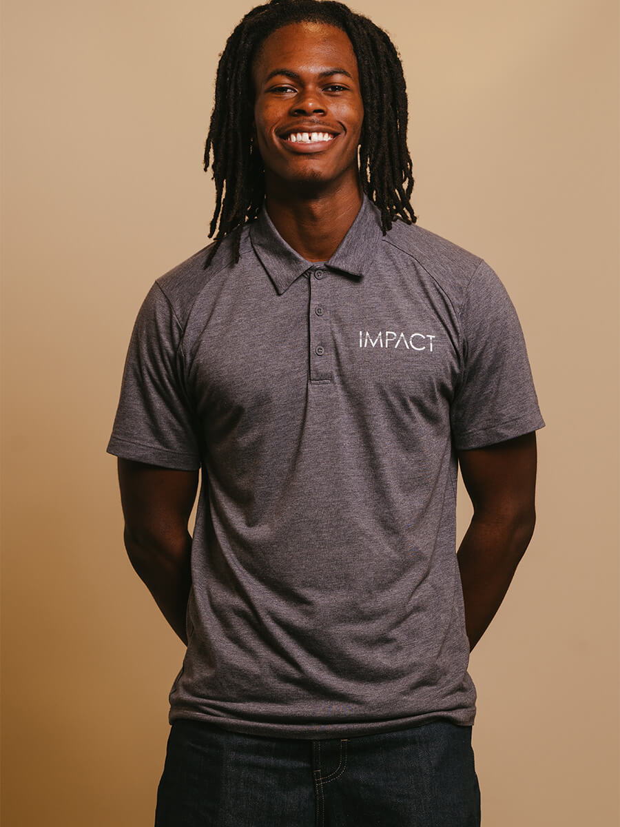 Headshot of student smiling wearing a grey collard shirt.
