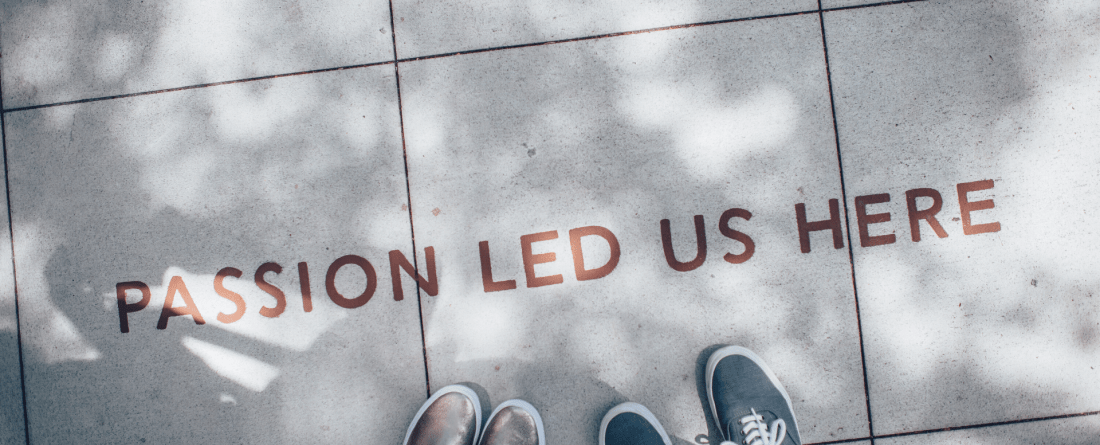 a photo of two feet on a sidewalk with the text "passion led us here"
