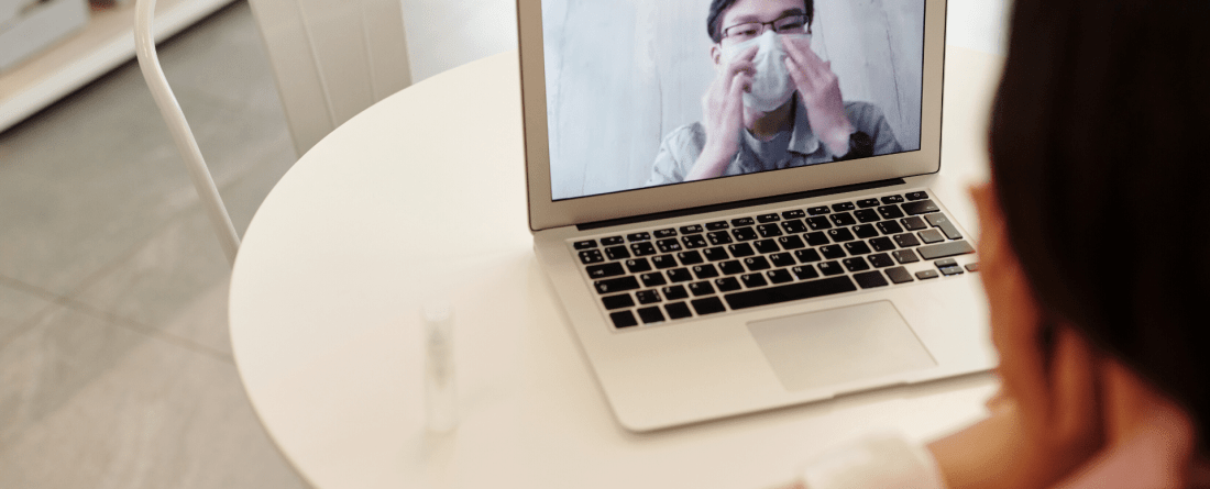 photo of a man on a computer screen with a mask
