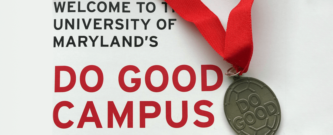 A Do Good Medallion is laying on top of a brochure that says, Welcome to the University of Maryland's Do Good Campus