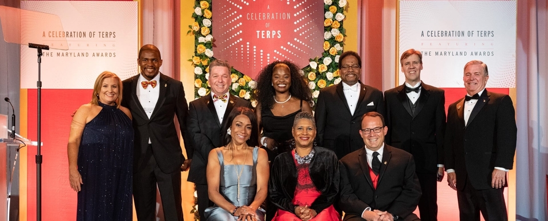 Honorees and special guests at the event included, from back left: Alumni Association Executive Director Amy Eichhorst, Cedric Nwafor ’18, Kirk Bell ’88, Lumnwi Audrey Awasom ’18, university President Darryll J. Pines, Jeff Kinney ’93 and Alumni Association Board of Governors President Jeffrey Rivest ’75. From front left: Dominique Dawes ’02, Dr. Sherita Hill Golden ’90 and Jeremy D. Rachlin, Esq. ’02. Not pictured: Reginald Dwayne Betts ’09.