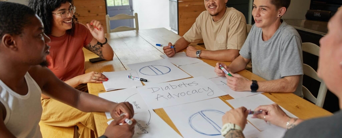 Students sitting around table collaborating