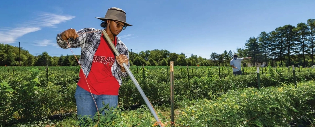 Student in a red Maryland t-shirt farming